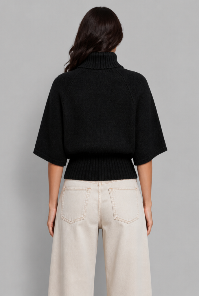 Black cable knit roll neck cape jumper back